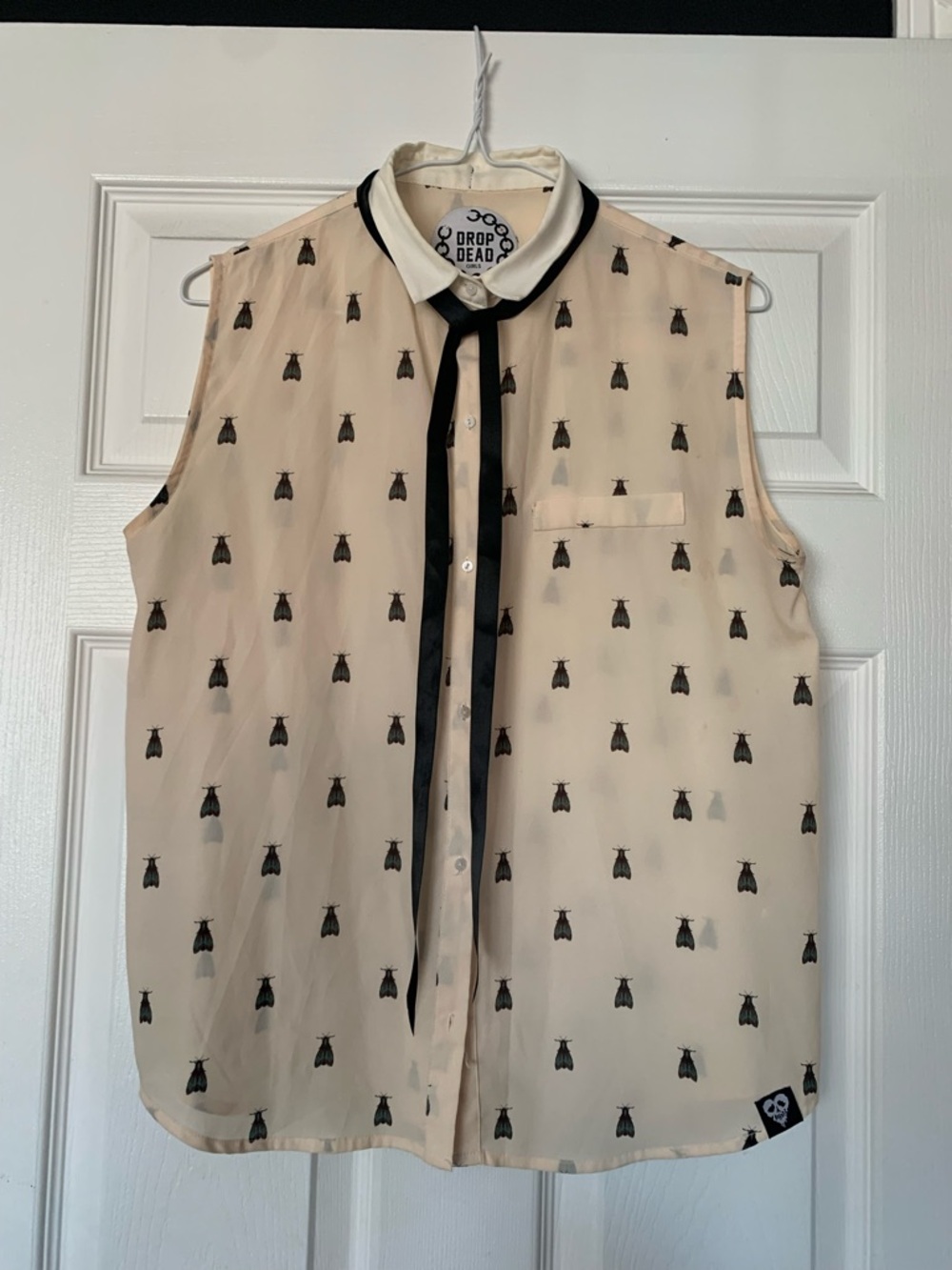 Drop Dead Sleeveless Cream Blouse with Black Trim and Bow Tie